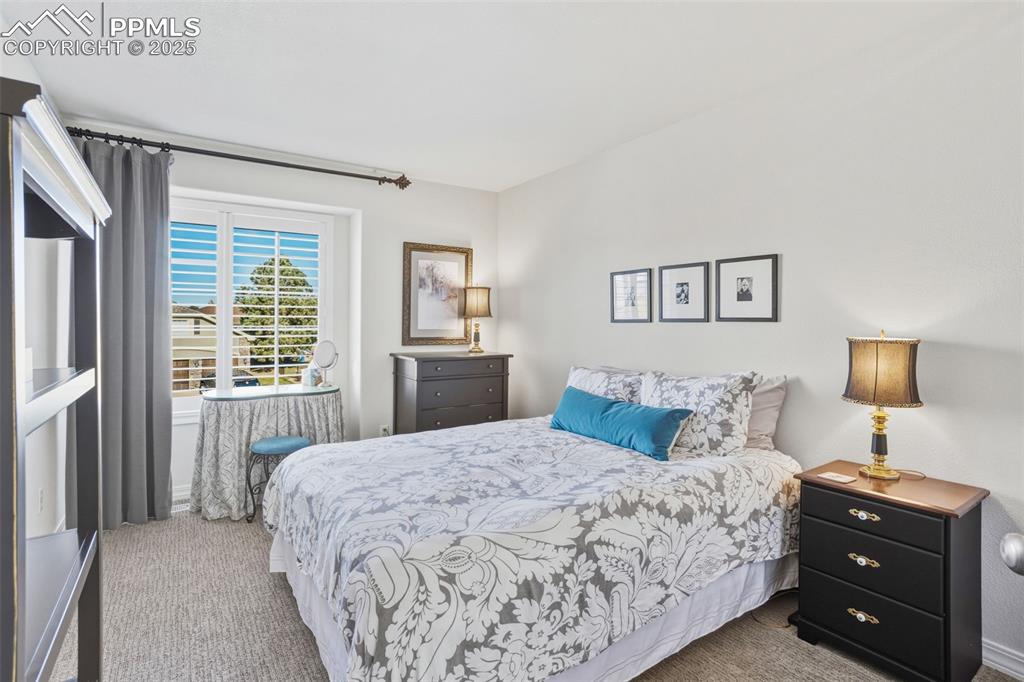 Bedroom featuring carpet and baseboards