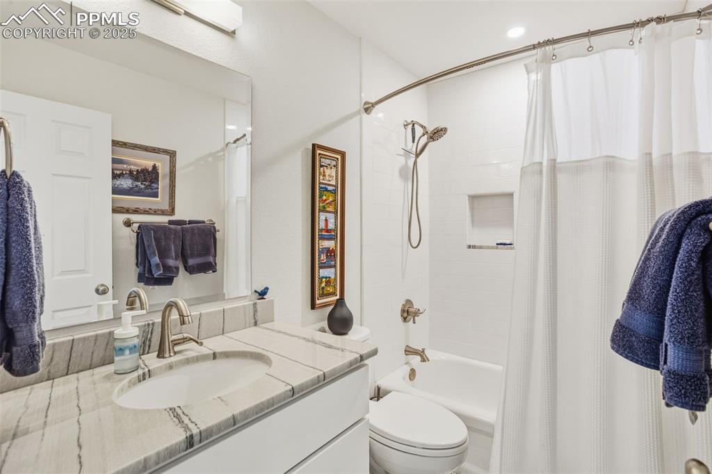 Full bath with vanity and shower / bath combo with shower curtain