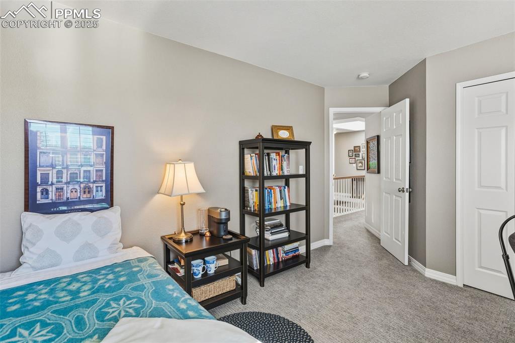 Bedroom with light carpet and baseboards