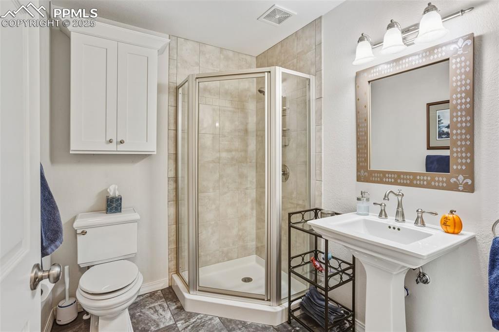 Full bathroom featuring a shower stall