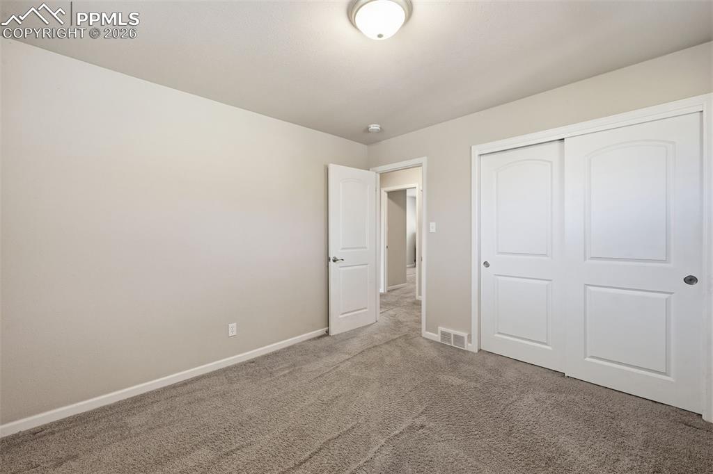 Large bedroom with large, high windows to accommodate all furniture