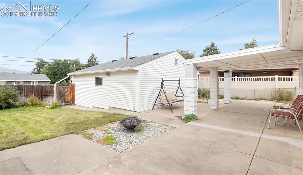 Inviting back yard with large covered patio, firepit, lawn, cute shed, and very large 2-1/2 car garage.