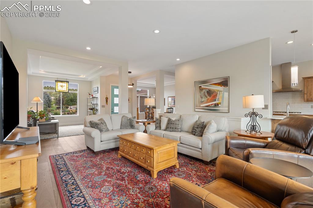 Open, light and bright family room has hardwood floor