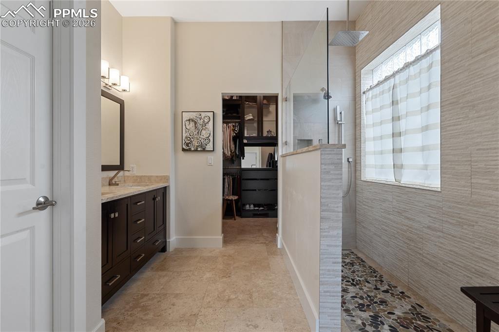 Updated master 3/4 bathroom has walk in 3 nozzle shower with stone floor