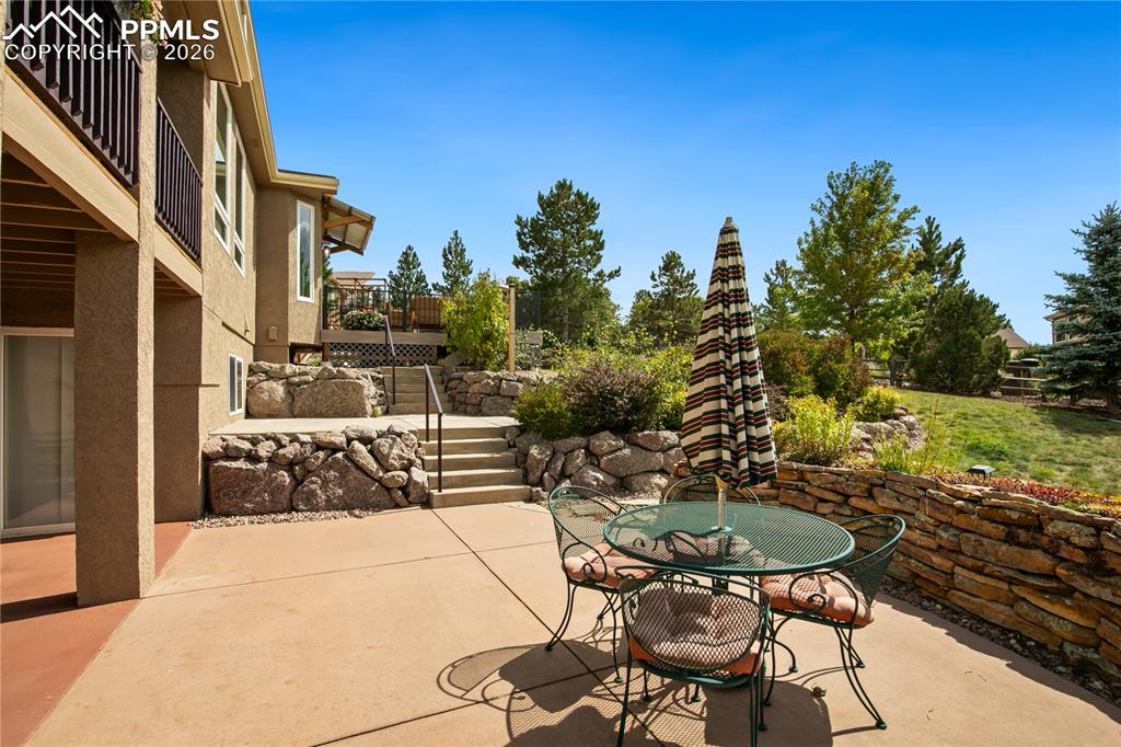 Backyard patio with beautiful low maintenance landscaping, mature trees