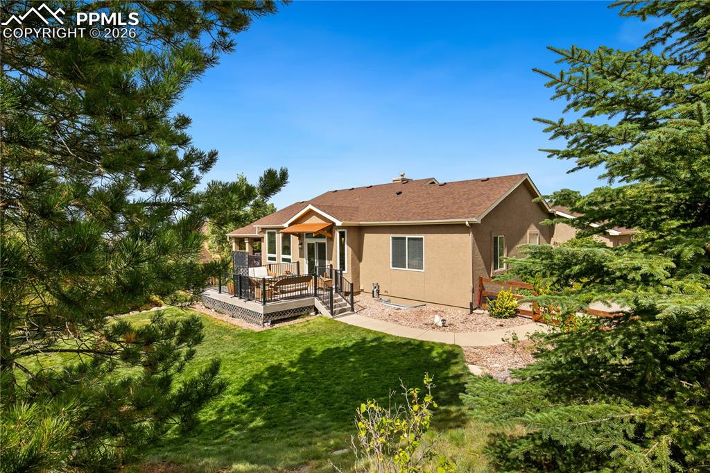 Back view of home with private backyard