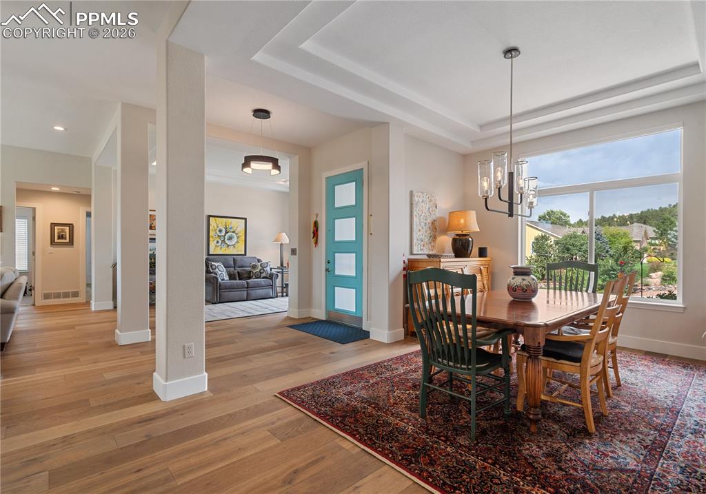 Formal dining room has hardwood floor , tray ceiling, and newer LED lighting