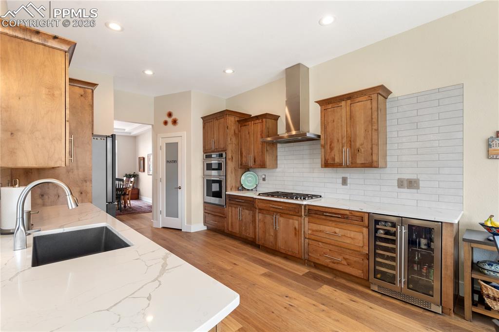 Remodeled gourmet kitchen has newer Italian tile backsplash, Quartz countertops, Zephyr dual zone beverage center, and pantry