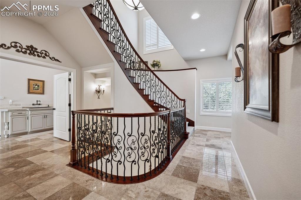 Hall featuring recessed lighting, baseboards, and a sink