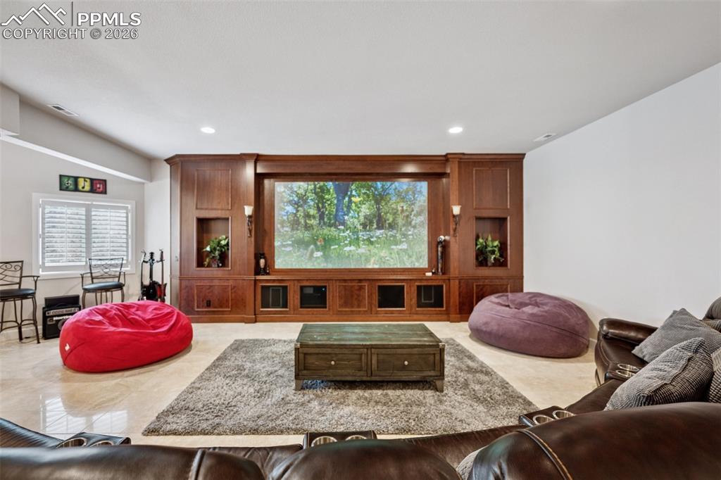 Living room featuring visible vents and recessed lighting