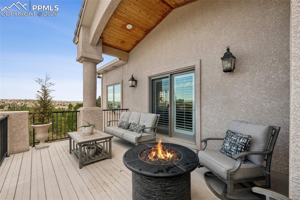 Wooden deck featuring an outdoor fire pit