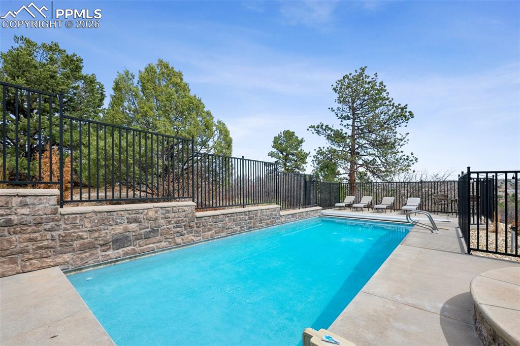 View of swimming pool featuring a fenced backyard, a patio, and a fenced in pool