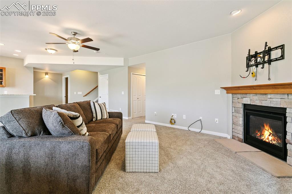 Family Room Featuring a Stone Fireplace