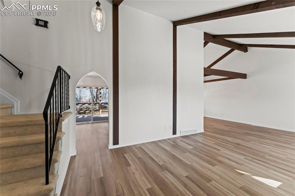 Living room w/ vaulted ceilings & real wood beams