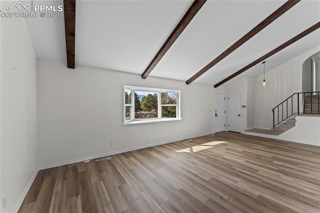 Living room w/ vaulted ceilings & real wood beams