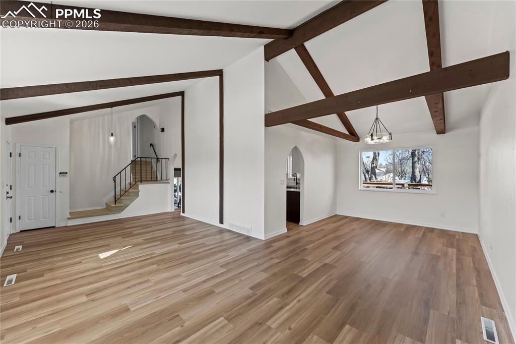 Living room w/ vaulted ceilings & real wood beams