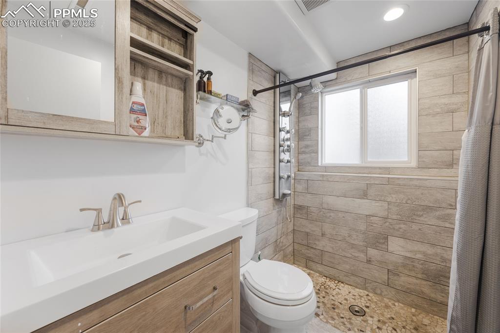 Full bathroom with a stall shower and vanity