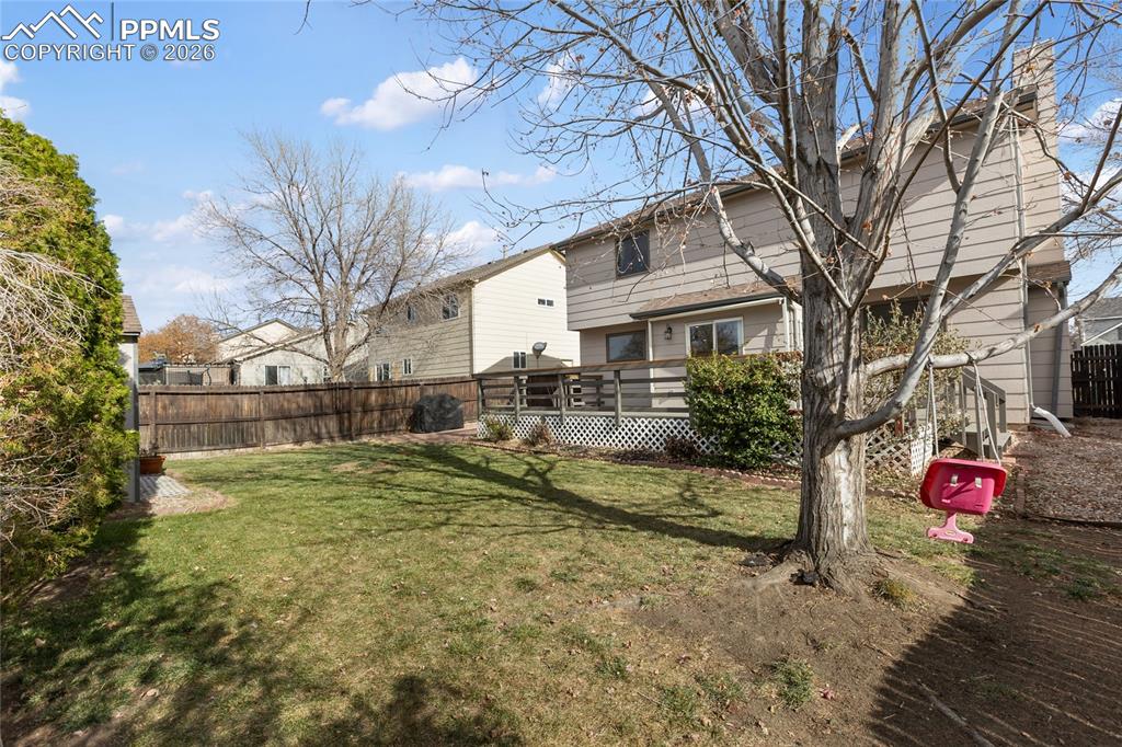 Back of house featuring a wooden deck