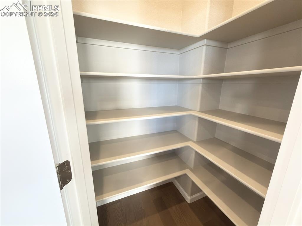 Spacious Kitchen Pantry with fixed Painted Wood Shelving.