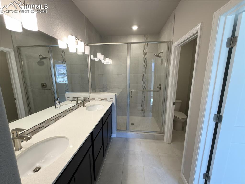 4 Piece Primary Bathroom with Quartz Countertops, Undermount Sinks, and Mudset Tile Shower Floor.