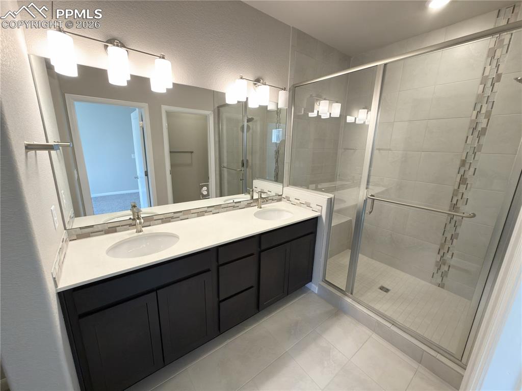 4 Piece Primary Bathroom with Quartz Countertops, Undermount Sinks, and Mudset Tile Shower Floor.