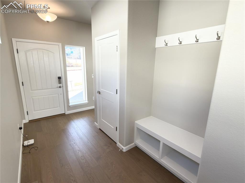 Welcome Home! Inviting Entryway with coat closet, bench with hooks, and engineered wood flooring!