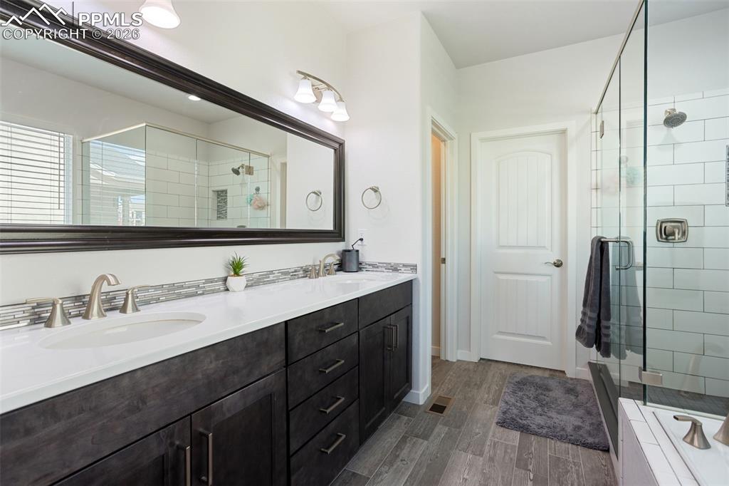 Primary 5 piece bath with double vanity and walk-in closet
