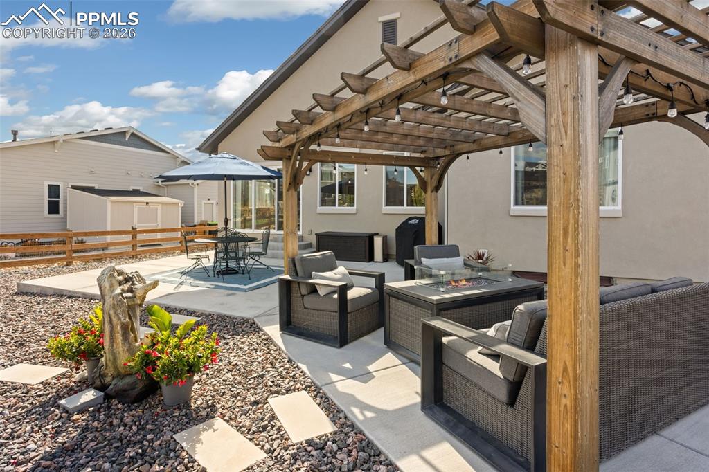 Enlarged back patio with 2 separate sitting areas and pergola
