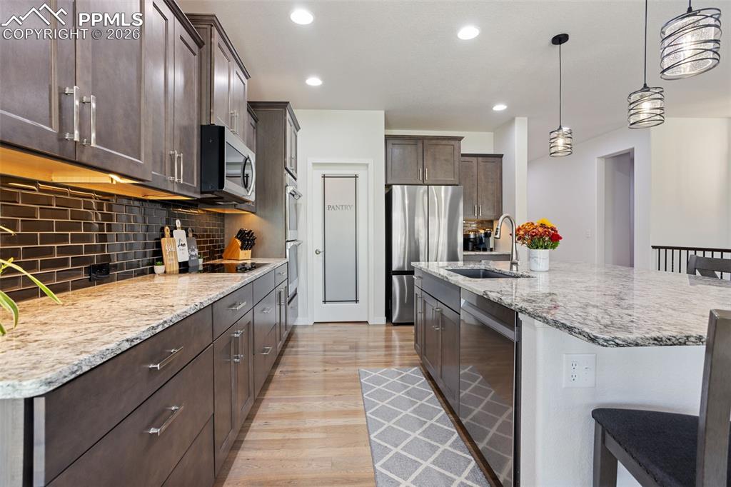 View from dining area of kitchen and large walk-in pantry