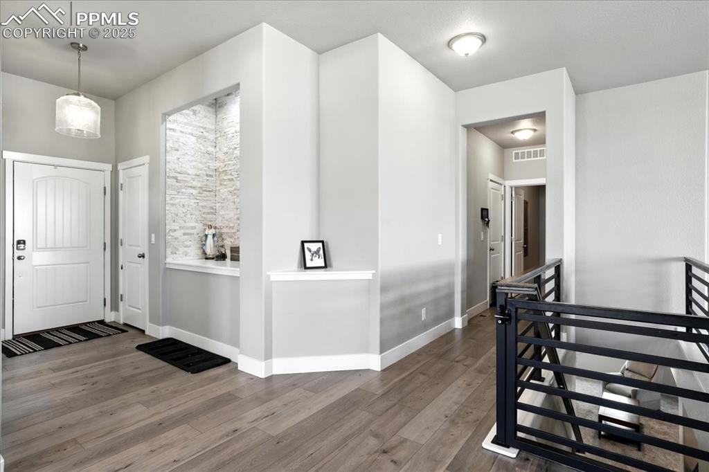 Foyer with wood finished floors and baseboards