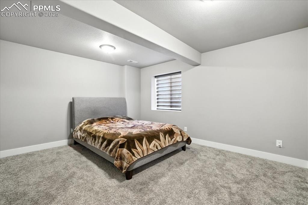 Bedroom featuring a textured ceiling and carpet