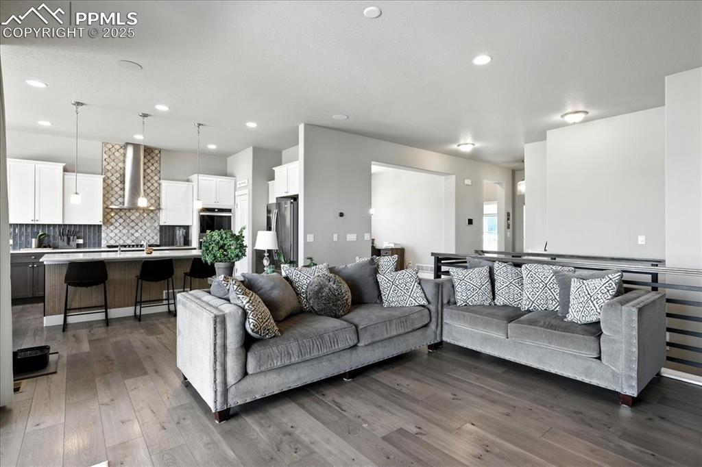 Living room featuring wood finished floors and recessed lighting