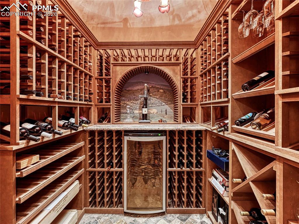 Wine room with wine frig, custom light fixture and custom mural artwork by local artist.