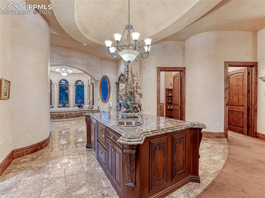 Primary suite w/wet bar and private laundry.