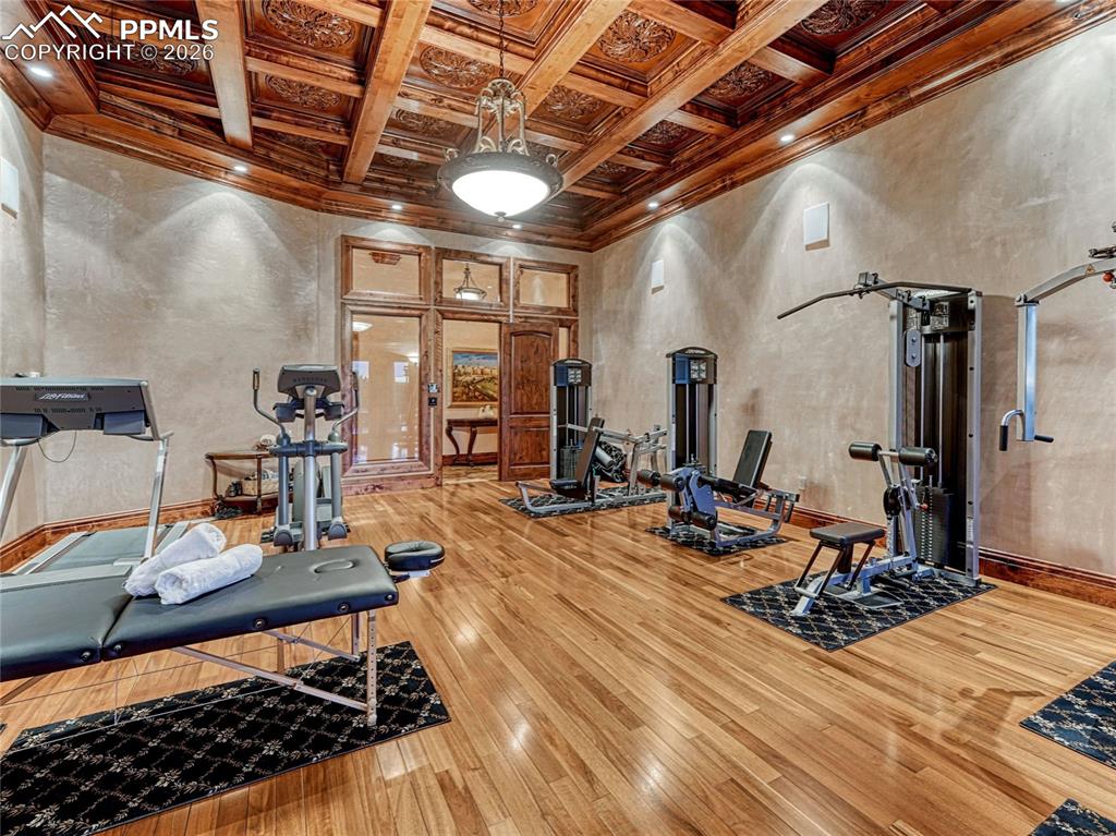 Fitness room w/outdoor access and hardwood flooring.