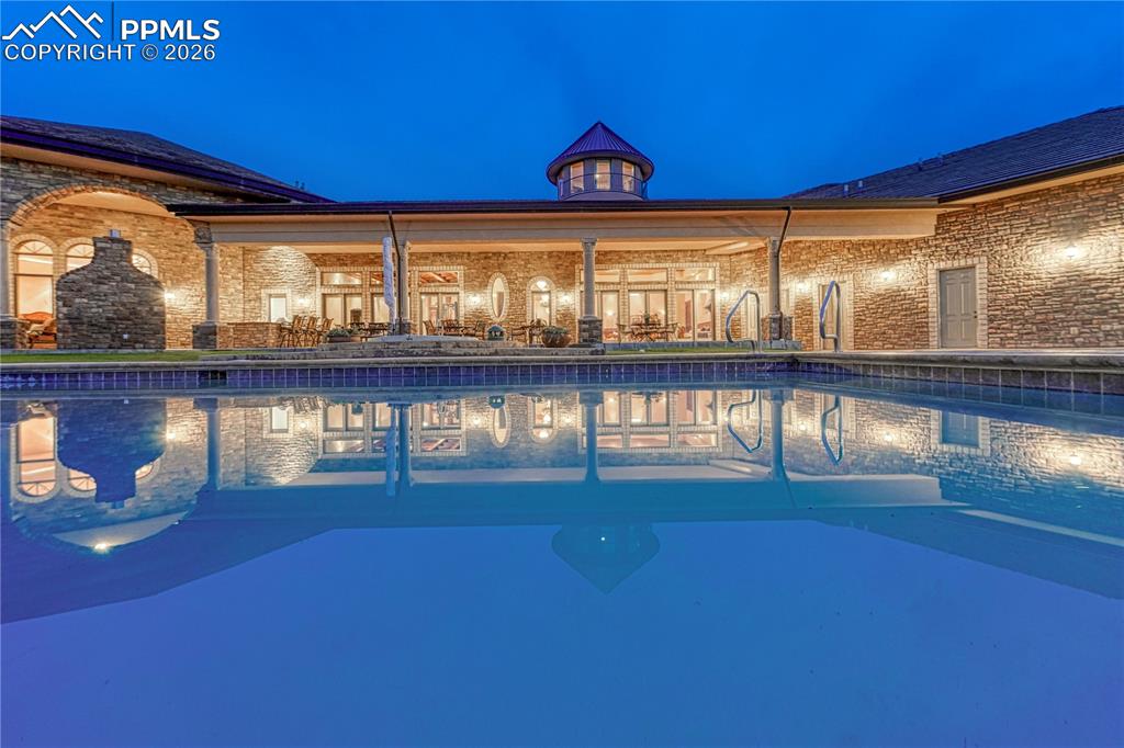 Outdoor pool with slide and diving board.