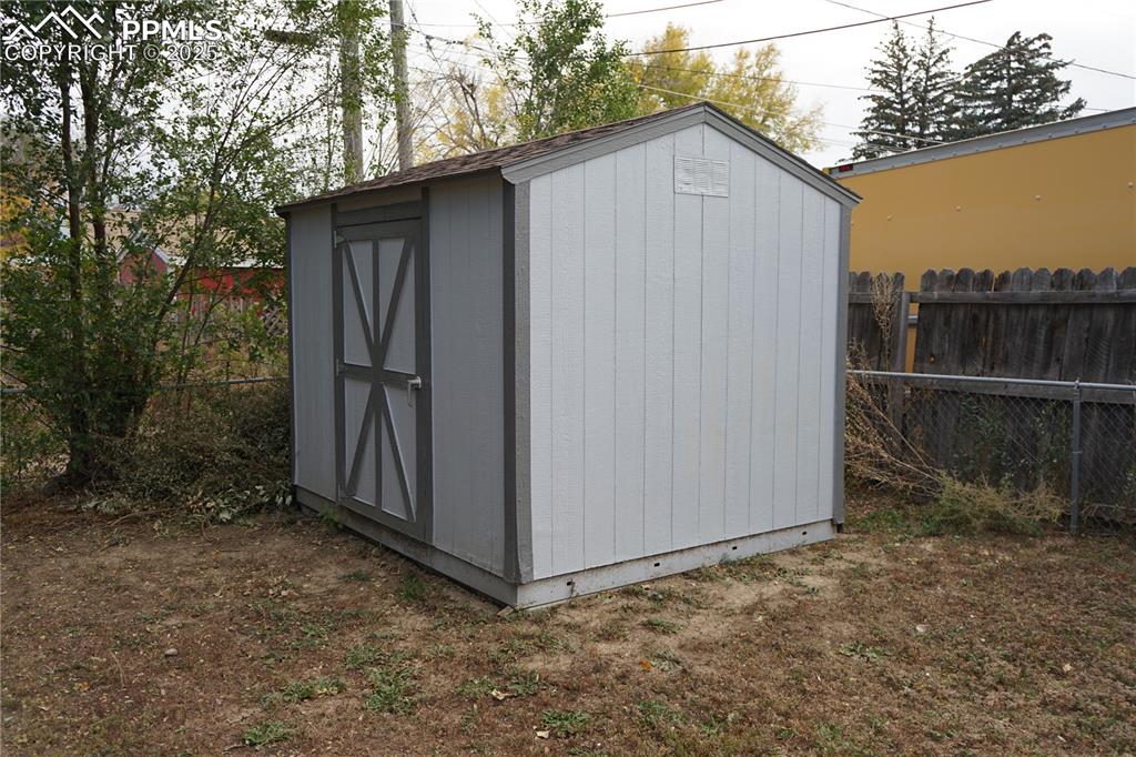 View of shed with a fenced backyard