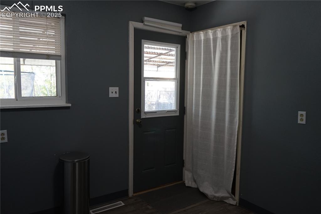 Doorway featuring wood finished floors