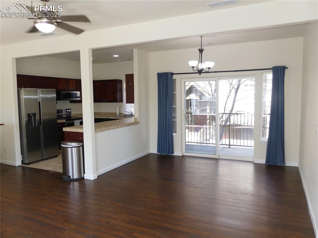 Dining area w/ a walk-out to the covered balcony area