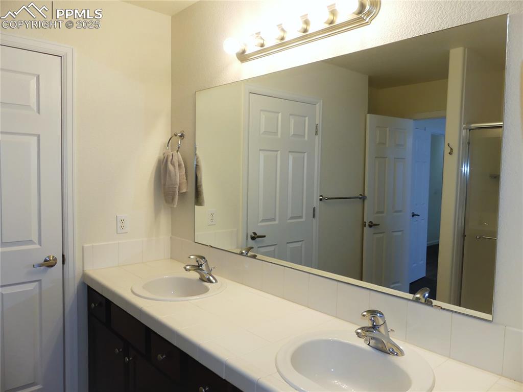 Bathroom featuring a sink and double vanity