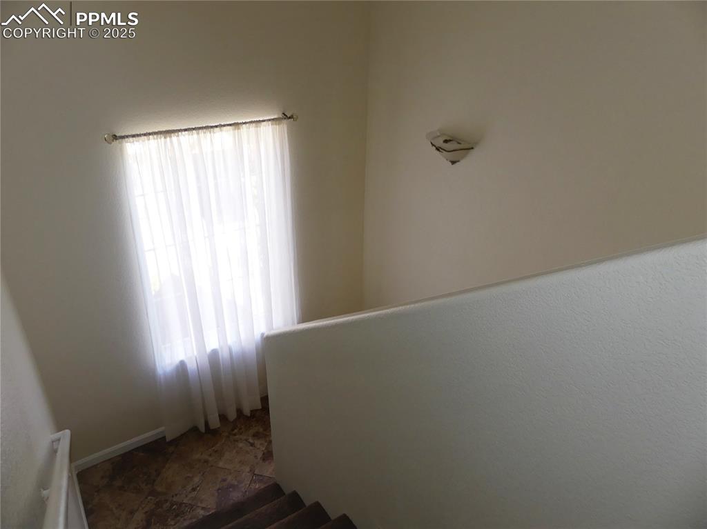 Stairway featuring stone finish flooring