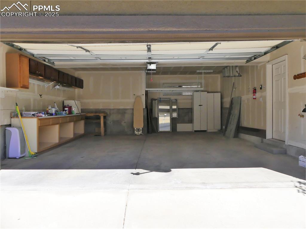 Garage featuring a garage door opener