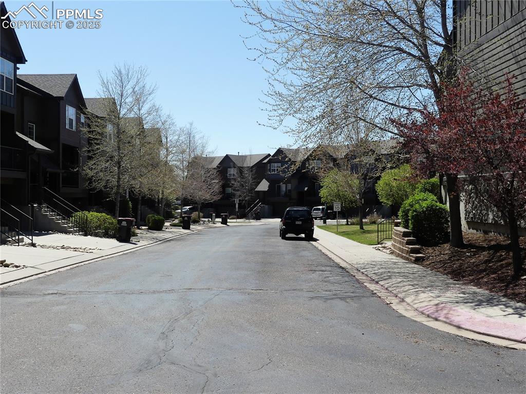 View of road featuring curbs, stairway, sidewalks, and a residential view