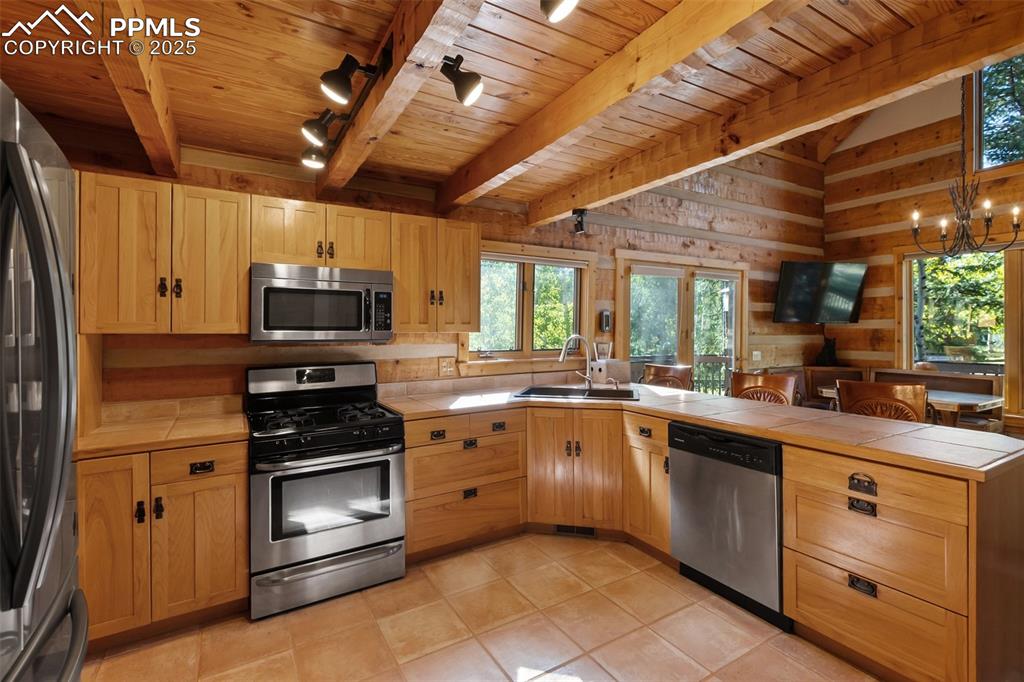 Dining area under chandelier. Door gives you access to the deck and steps to the ground level.