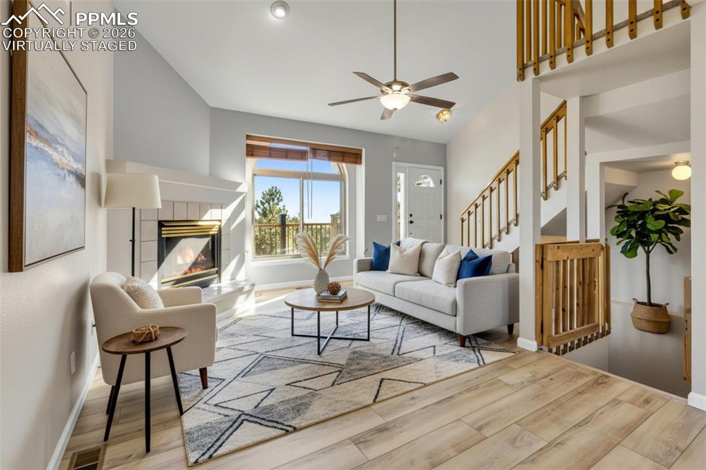 VIRTUALLY STAGED. Welcome inside...Living area with a tiled gas fireplace, new LVP flooring, new interior paint, high ceilings and tons of natural light. 
