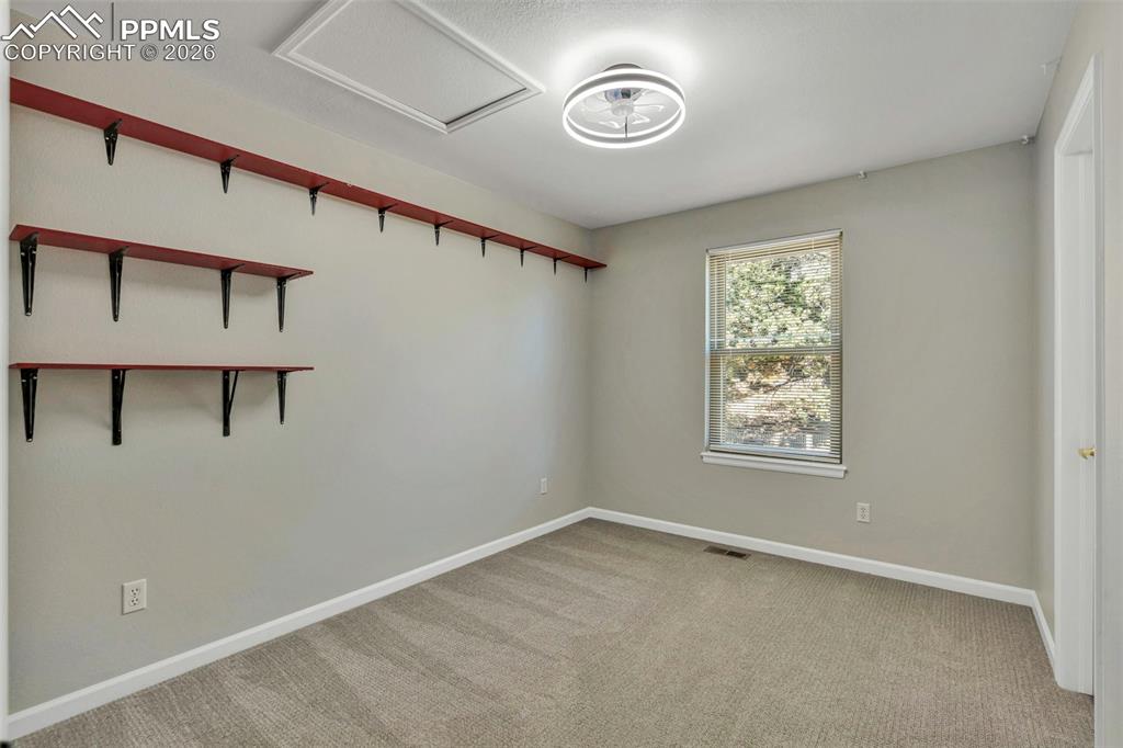 Unfurnished room featuring light carpet and baseboards