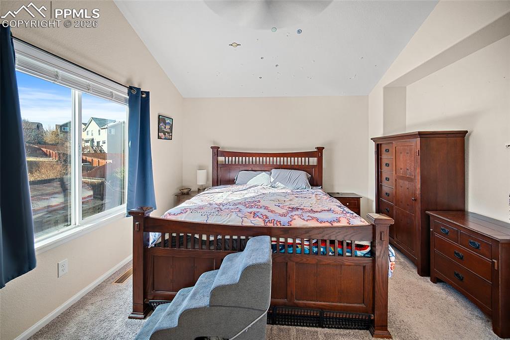 A spacious master suite complete with vaulted ceilings, en suite, and large walk-in closet