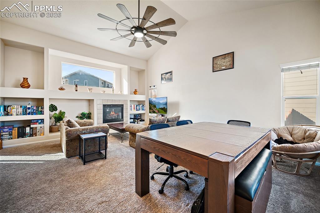 Enter into the living room with vaulted ceilings, a gas fireplace, and loads of natural light. 