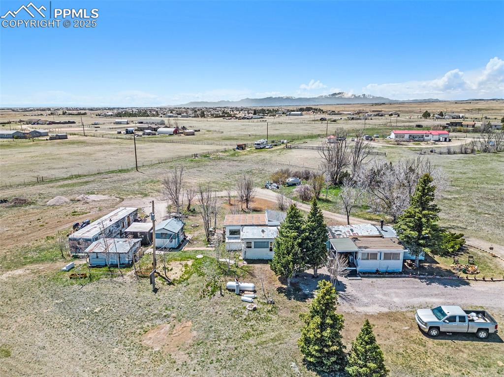 Birds eye view of property featuring a mountain view and a rural view