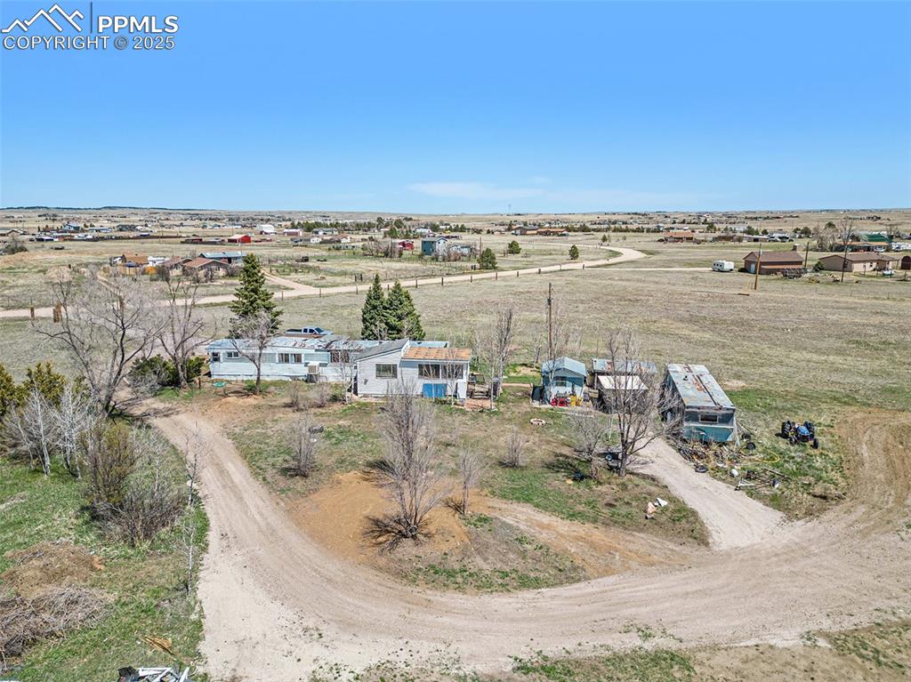 Birds eye view of property with a rural view